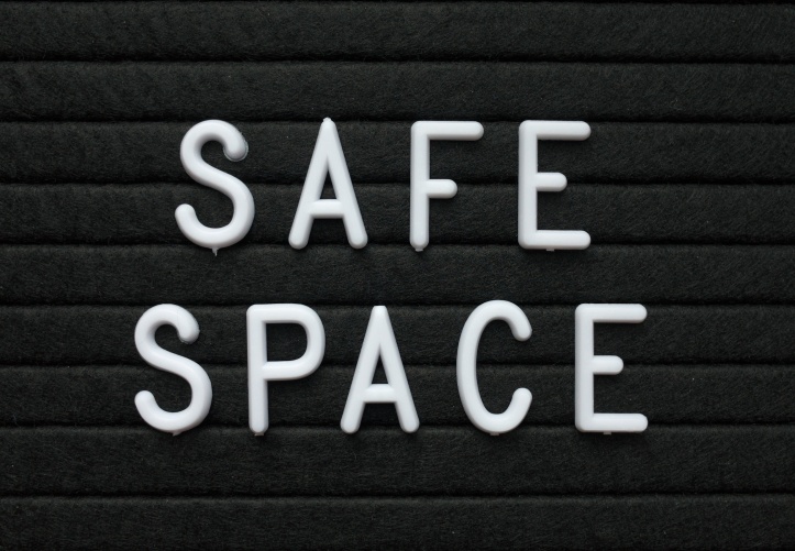 The words Safe Space in white plastic letters on a black letter board to indicate a place or environment where people can feel protected